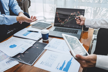 Businessman investor on meeting having planning and analyzing of partner cooperation in investment trading marketing project and pointing on the data presented and deal on a stock exchange to profit