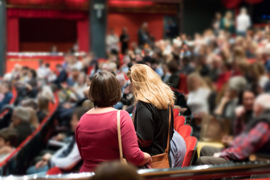 theater audience arriving and taking seats before the performance