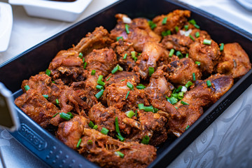 A food bowl of peppered chicken