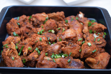 A food bowl of peppered chicken