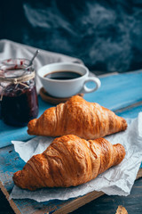 delicious croissants on wooden table