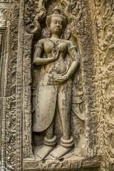 Sculptures of a beautiful woman on the wall of a temple in Angkor Wat, Cambodia