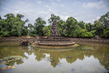 Fototapeta na wymiar Ancient circular fountain filled with water from Angkor Wat, Cambodia