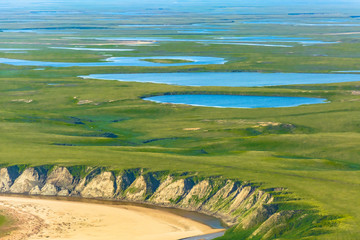 Landscape of the arctic tundra in summer. Rivers, lakes, northern vegetation. View from above. The...