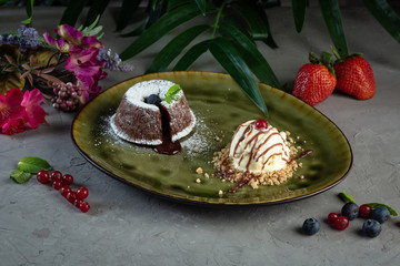 chocolate flan and scoop of ice cream in a green plate