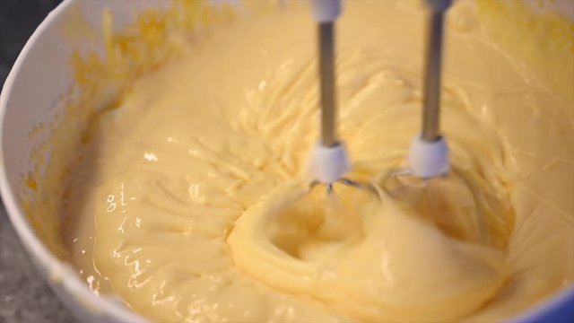 Mixing cake batter with electric mixer 