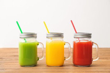 Mason jars of fresh juice on table