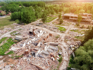 Aerial drone view of old demolished industrial building. Pile of concrete and brick rubbish, debris, rubble and waste of destruction ruins of abandoned actory or plant. Earthquake city landscape