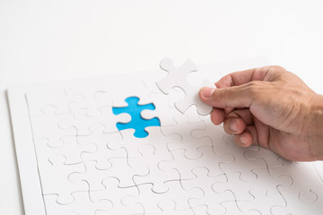 Hand holding jigsaw piece. for business concept
