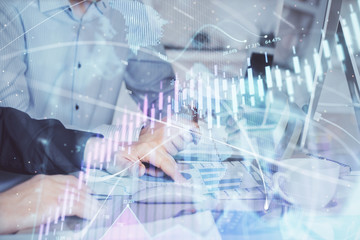 Multi exposure of chart with man typing on computer in office on background. Concept of hard work.