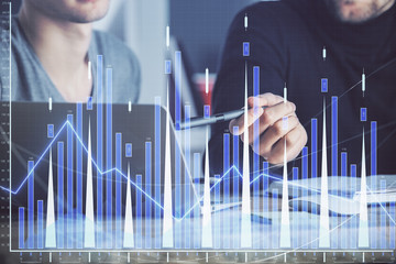 Forex graph with businessman typing on computer in office on background. Concept of analysis. Double exposure.