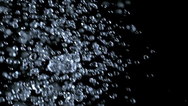 Super Slow Motion Shot of Water Shower at 1000fps Isolated on Black Background. Shooted with High Speed Cinema Camera at 4K Resolution.
