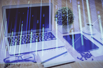Forex market graph hologram and personal computer on background. Double exposure. Concept of investment.