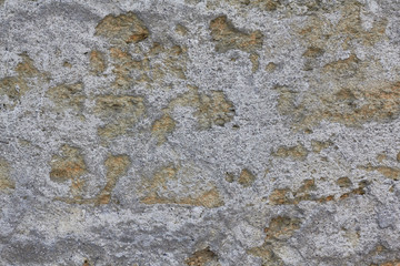 texture of a stone wall with traces of cement, bumps, yellow stone