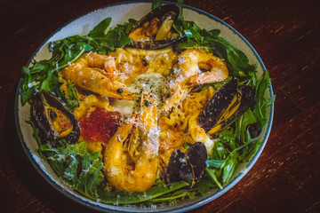 Pink sauce pasta (a mixture of Pomodoro and Carbonara), Grated Parmesan, Extra Virgin Olive Oil, Arugula, Sous Vide Egg, Calamari, Black Lump Fish Caviar, Black Truffle Pate, Prawns