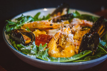 Pink sauce pasta (a mixture of Pomodoro and Carbonara), Grated Parmesan, Extra Virgin Olive Oil, Arugula, Sous Vide Egg, Calamari, Black Lump Fish Caviar, Black Truffle Pate, Prawns