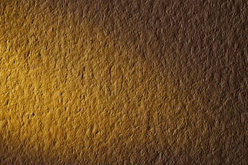 Golden light from window on the wall at morning texture