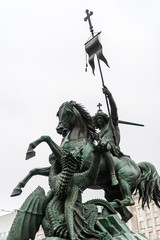 Statue of St George on a horse killing the Dragon. On river site Spree River and facing the old St...