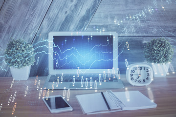 Double exposure of chart and financial info and work space with computer background. Concept of international online trading.