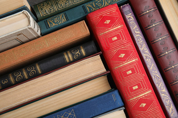 Stack of hardcover books as background, above view