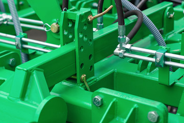A fragment of the details of the mechanism of agricultural machinery close-up / abstract industrial technology background.