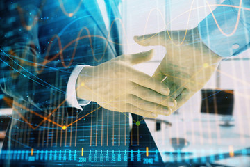 Multi exposure of financial graph on office background with two businessmen handshake. Concept of success in business