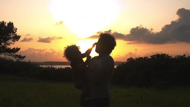 Precious View of a Father Playing with His Adorable Son on a Sunset