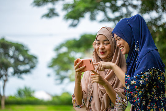 Two Asian woman musalim selfie in the garden.
