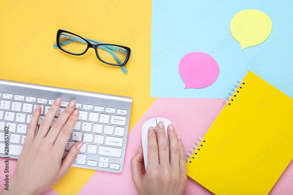 Fototapete female hands typing on computer keyboard with notepad and glasses