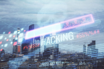 Double exposure of hacking theme drawing hologram on cityscape background. Concept of data cyber piracy