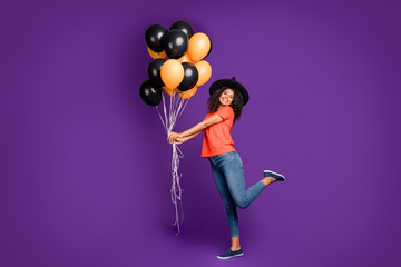 Fototapeta na wymiar Full length body size side profile photo of cheerful positive cute nice charming pretty girlish youngster holding balloons filled with helium wearing jeans denim smiling toothily playing kind witch