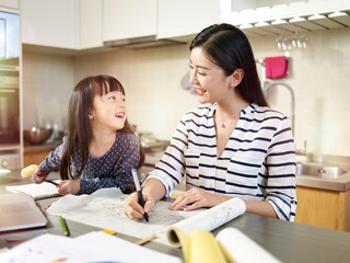 Obraz premium young asian mother enjoying working at home