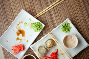 Empty dirty plate of sushi on table in cafe