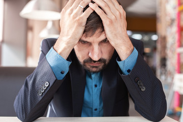 Man holding his head and upset
