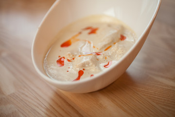 Chicken fillet in a cream sauce in a white dish