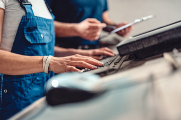 Female CNC operator write fabrication program on the computer