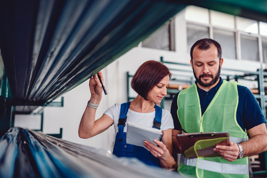 Warehouse Workers Checking Order List