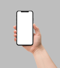Woman hand holding smart phone with blank screen isolated on gray. Template, mockup, model, modern, design.	