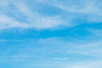 Blue sky with soft white clouds.