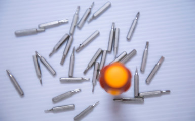 Yellow and red hand screwdrivers and screws isolated on white background. Top view.