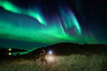 Woman below the Northern lights