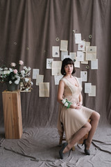 Portrait of a young beautiful woman with dark hair. Beautiful young brunette with flowers. Romantic portrait