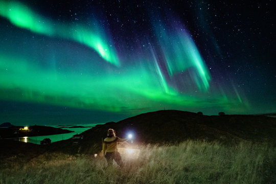 Woman below the Northern lights