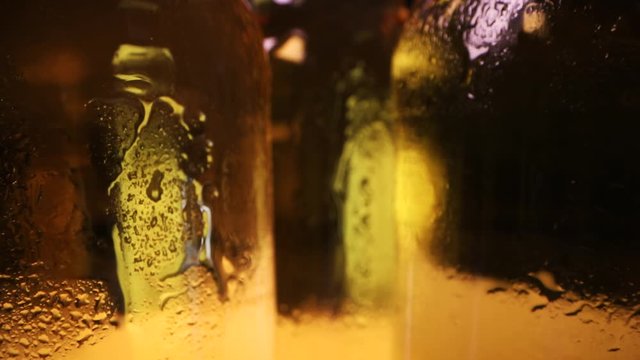 closeup of cold beer bottles with water drops. dolly shot