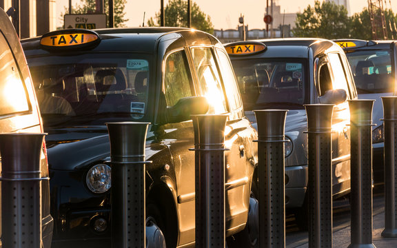 London black taxi cabs at a rank waiting for passengers in the Docklands business district.