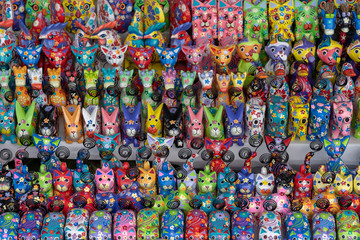 Sale of souvenirs - funny handmade wooden animals in street market. Bright colorful children toys and decoration for interior. Ubud, Bali island, Indonesia. Closeup