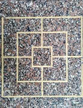 Aerial view on a rectangular merels game on a granite table