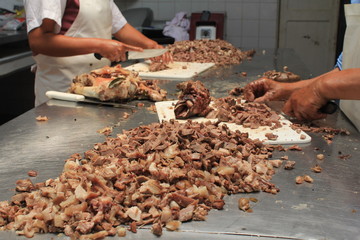 cutting pieces of meat in the table