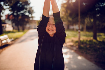Girl making funny faces with arms raised
