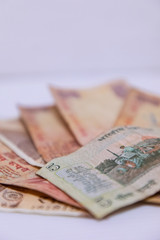 Fototapeta premium Closeup of brand new colorful Indian currency bank notes of 5 and 10, 20 rupees - white background with space for text